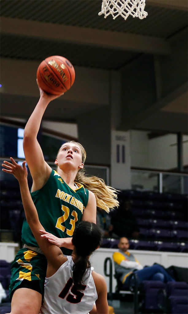 Rock Bridge senior Eryan Puett jumps over towards the basket